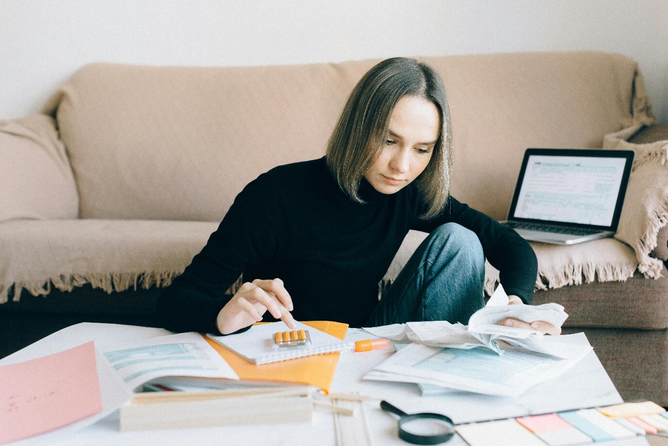 Woman using a calculator on desk