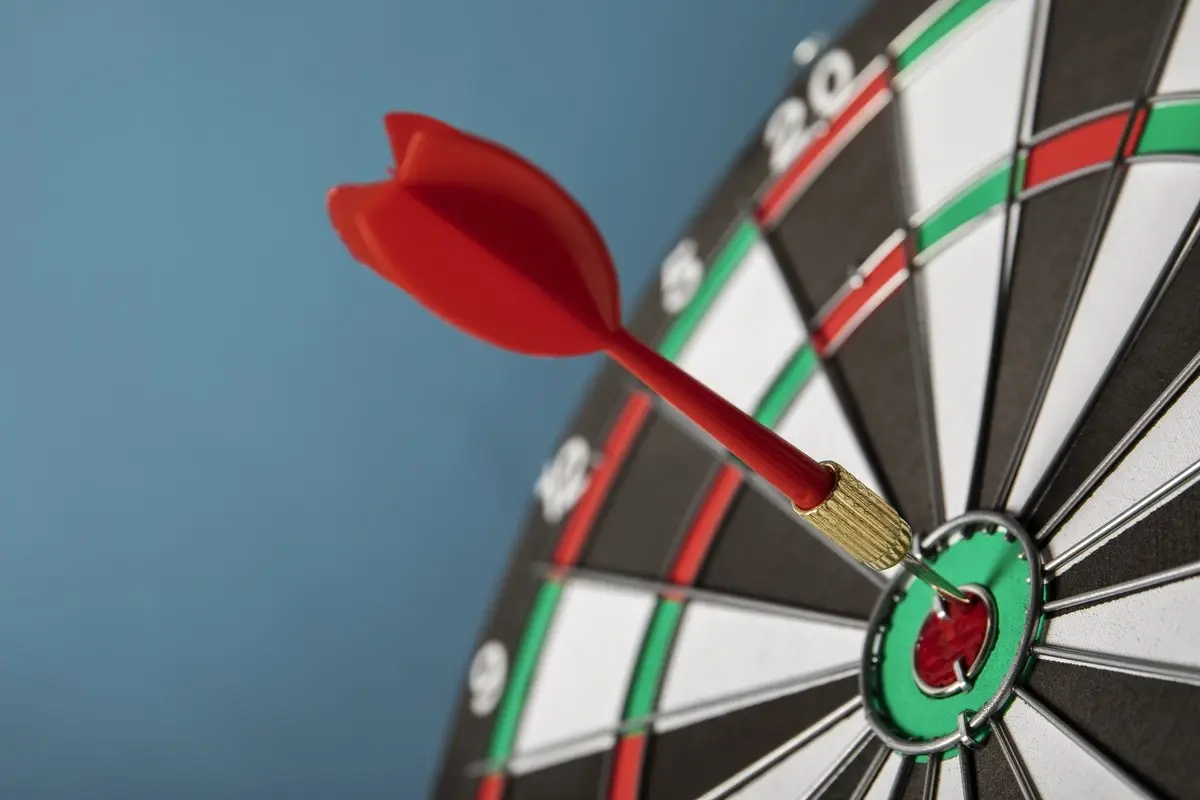 Dart hitting the bullseye on a dart board